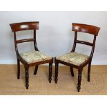 A set of four William IV mahogany dining chairs, with upholstered seats, on turned legs,