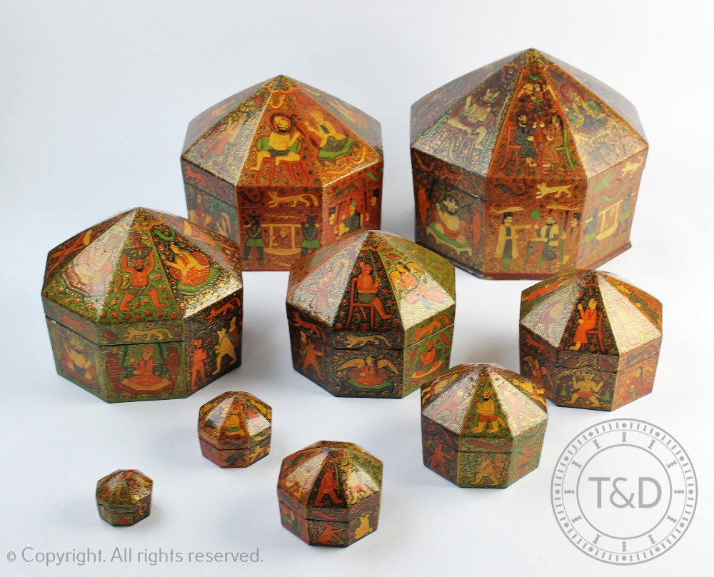 An early 20th century Indian lacquered papier mache graduated set of nine octagonal boxes and