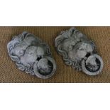 A pair of reconstituted stone lions mask wall mounts,