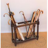 A Victorian carved oak oak stick stand, two section, on bobbin turned legs,