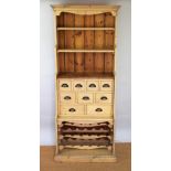 A modern pine dresser, of slender proportions, with an arrangement of nine drawers,