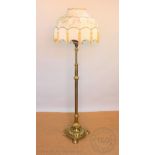 A late Victorian brass oil standard lamp converted for electricity, with fluted column,