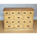 A 19th century style pine bank of drawers/chest, with an arrangement of sixteen drawers,