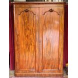 A Victorian mahogany wardrobe, with two moulded doors enclosing four press trays and three drawers,