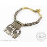 A Bedouin tribal Hirtz type white metal necklace,