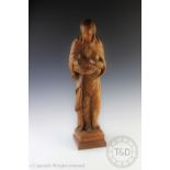 A carved pine figure of The Virgin Mary and infant Christ, on moulded plinth base,