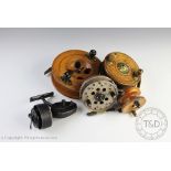 A vintage walnut sea reel, the 11cm diameter reel with brass star back centre pin,
