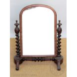 A William IV mahogany toilet mirror, with barley twist uprights on scroll legs,