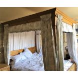 A modern golden oak super king size four poster bed, with panelled canopy and head and foot boards,