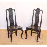 A pair of Victorian carved oak chairs, the solid splats carved with fruiting vines,