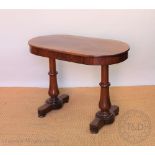 A Victorian mahogany oval table, with turned legs,