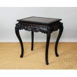 A late 19th century Chinese carved and stained softwood occassional table,