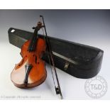 A late 19th/early 20th century violin, with one piece back and ebonised stringing,