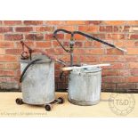 Two vintage galvanised hand water pumps, both with cast iron handles,