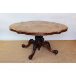 A Victorian walnut serpentine loo table, with quarter veneered top,