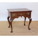 A George III style mahogany low boy, with three drawers on cabriole legs,