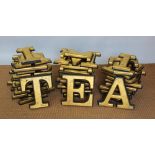 A collection of forty two gilt wood and rubber advertising letters,