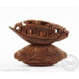 A Chinese carved coquilla nut modelled as a junk,