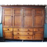 A late George III / early 19th century oak housekeepers cupboard,