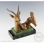 A French Art Deco patinated bronzed spelter family of three deer, modelled upon a marble base, 19.
