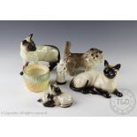 Four Beswick cats comprising; a Persian cat modelled standing in grey gloss,
