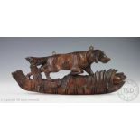 A black forest carved wall mounting hanging rack designed as a Setter stalking a partridge,