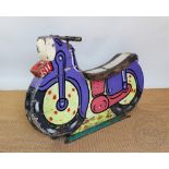 A 1950's metal and painted wood fairground ride motorbike, in purple livery,