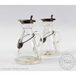 A pair of glass and silver mounted whisky toddy jugs or noggins, Hukin and Heath, Birmingham 1907,