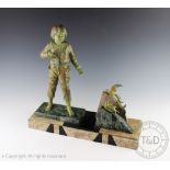 A large French Art Deco patinated bronzed spelter group of a boy,