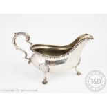 A George III silver sauce boat, London 1775, indistinct makers mark, of typical form,