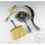 A selection of silver comprising; a George V silver handled crumb brush, William Henry Leather,