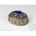 A late 19th century white metal oval box and cover,