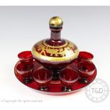 A late 19th century French gilt ruby glass liqueur set, comprising decanter and stopper,