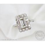 An Art Deco diamond rectangular cluster ring, designed as a central baguette cut diamond,