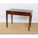 A George III style walnut writing table, with two drawers, on tapered square legs,