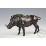 A Tahir bronze model of warthog, modelled standing, signed 'MT',
