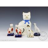 A Staffordshire model of a seated cat, with blue ribbon collar, 20cm,