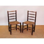 A pair of early 19th century elm country kitchen chairs, with 'cricket bat' shaped bar backs,