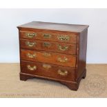 A George III oak chest, of four graduated long drawers, with later brass handles, on bracket feet,