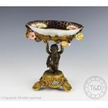 A late 19th century French bronze and gilt brass figural comport, the bow with floral encrusting,