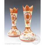 A pair of Japanese Kutani vases, with shaped rims and decorated with panels of birds and figures,