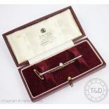 A diamond set solitaire bar brooch, the white metal bar set with a central old cut diamond,