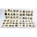 A collection of sixty military cap badges, to include Royal Berkshire, Royal West Kent,