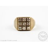 A diamond set signet ring, designed as a square panel of nine brilliant cut diamonds,