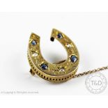 A Victorian sapphire and diamond horseshoe brooch, set with four sapphires and three diamonds,