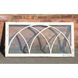 A late Victorian painted wood window, possibly a fan light, with arched detailing,