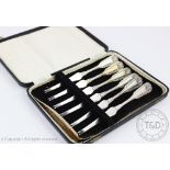 A cased set of six Belgian silver lobster forks, each with shell cast terminals, 19.