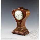 An Art Nouveau brass inlaid mahogany and walnut timepiece,