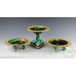 A Wedgwood majolica dessert service comprising; a tazza upon an entwined trefoil dolphin base, 18.