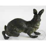 An Austrian cold painted bronze figure of a hare, modelled crouching with raised ears,